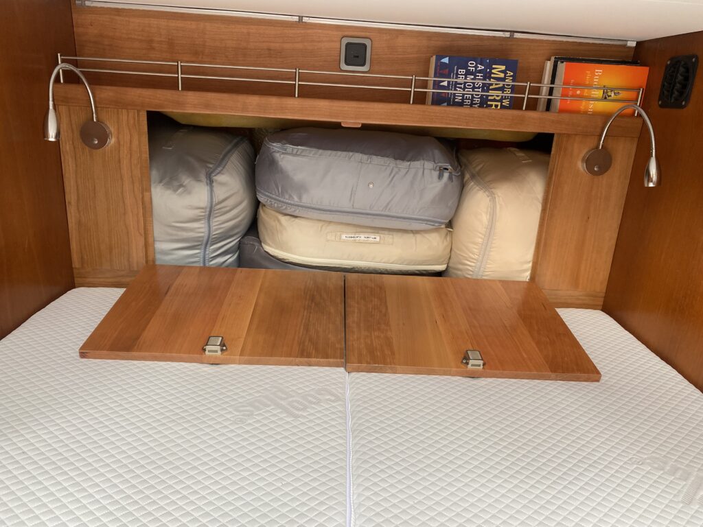 The finished headboard with access hatches in to the transom and a shelf for books, drinks and teddy