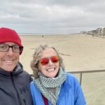 The beaches of Dunkirk behind Chris and Jen