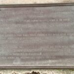 A plaque with an inscription outside Lion-Sur-Mer