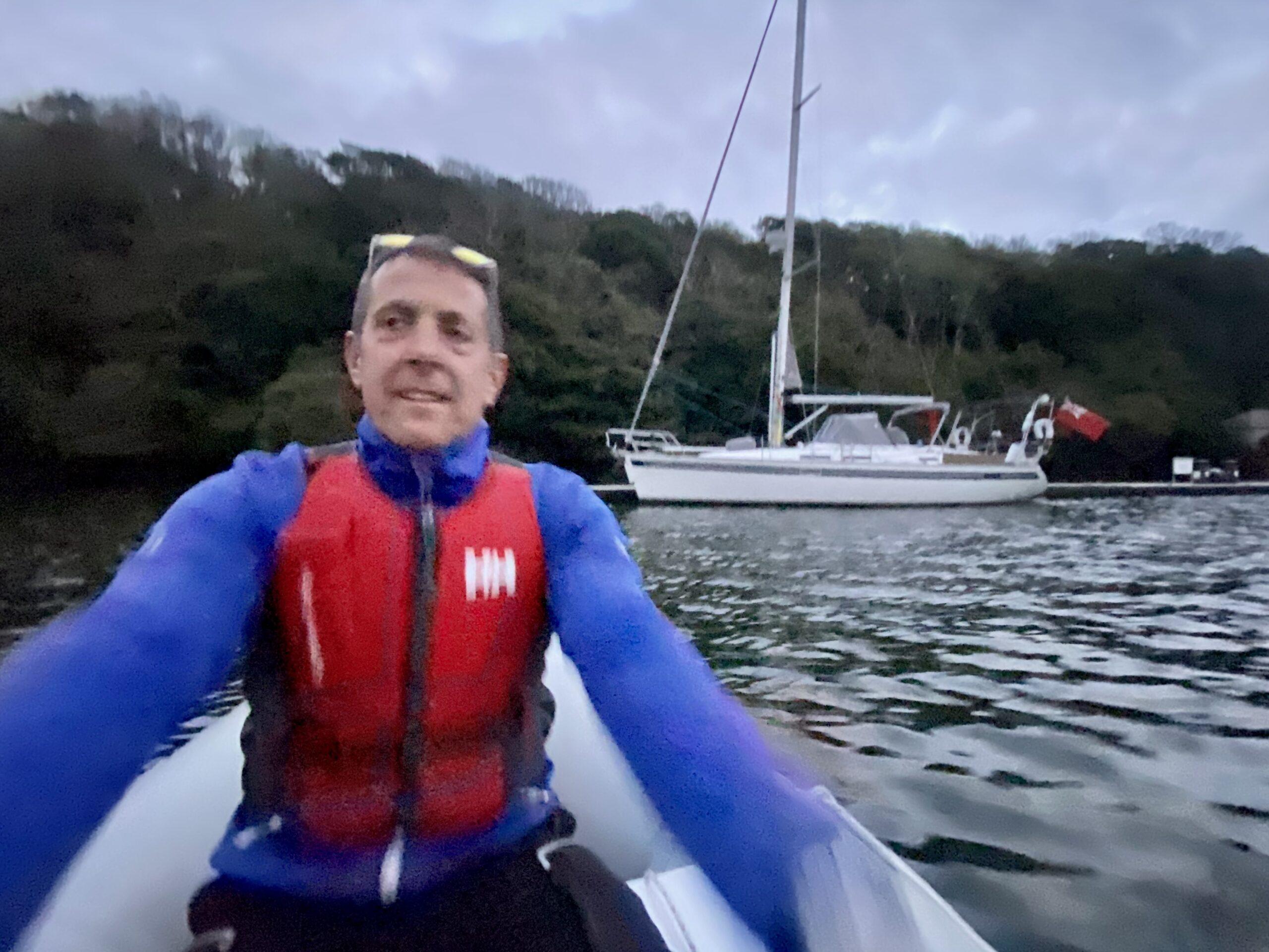 Chris rowing over to Yanula Blue in Fowey 
