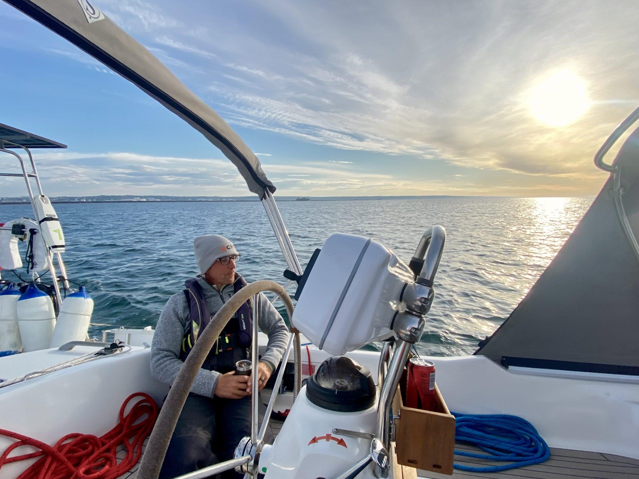 Chris settles in for a long passage as the sun goes down