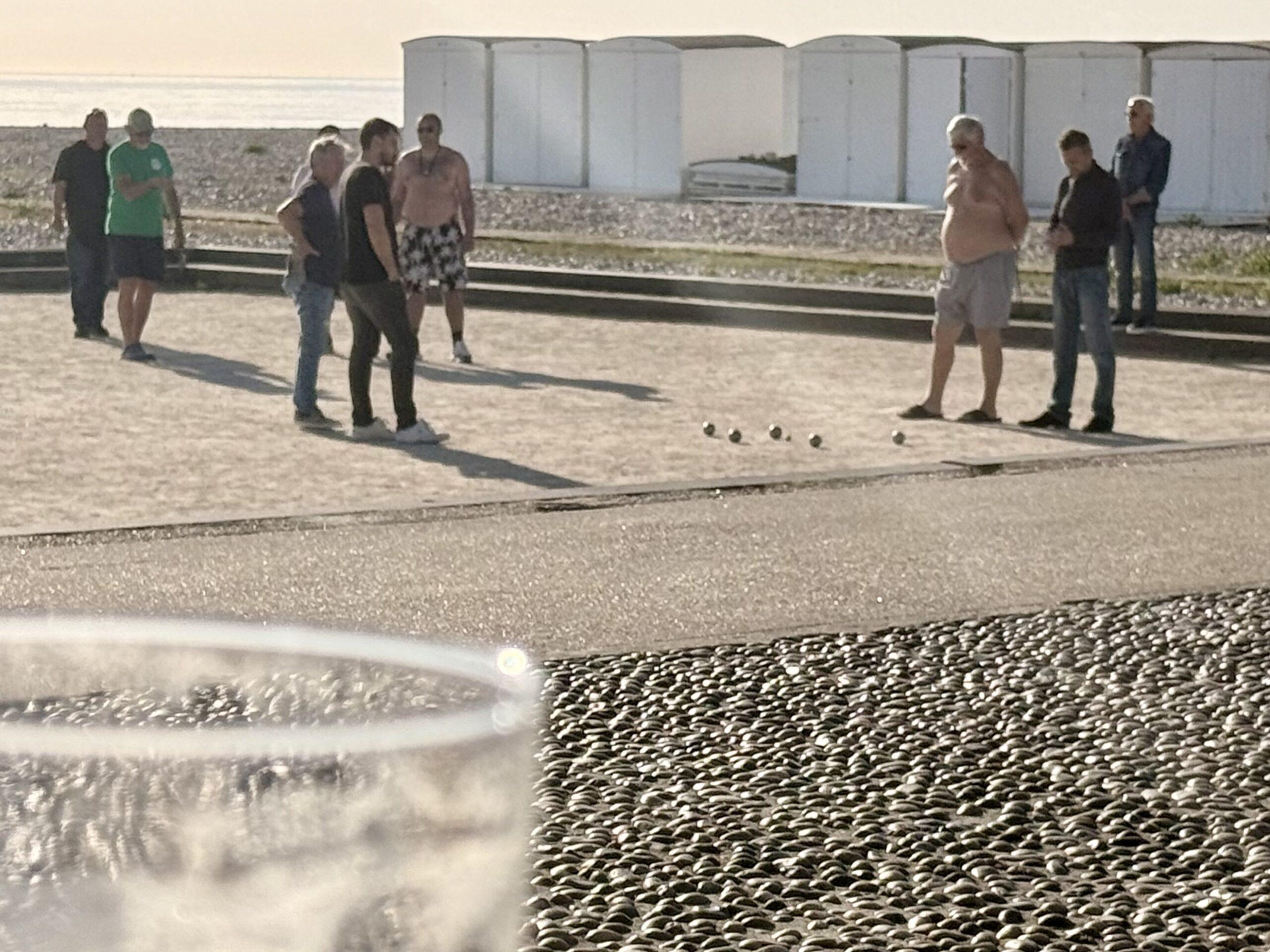 Watching the locals playing petanque enjoy a frothy beverage